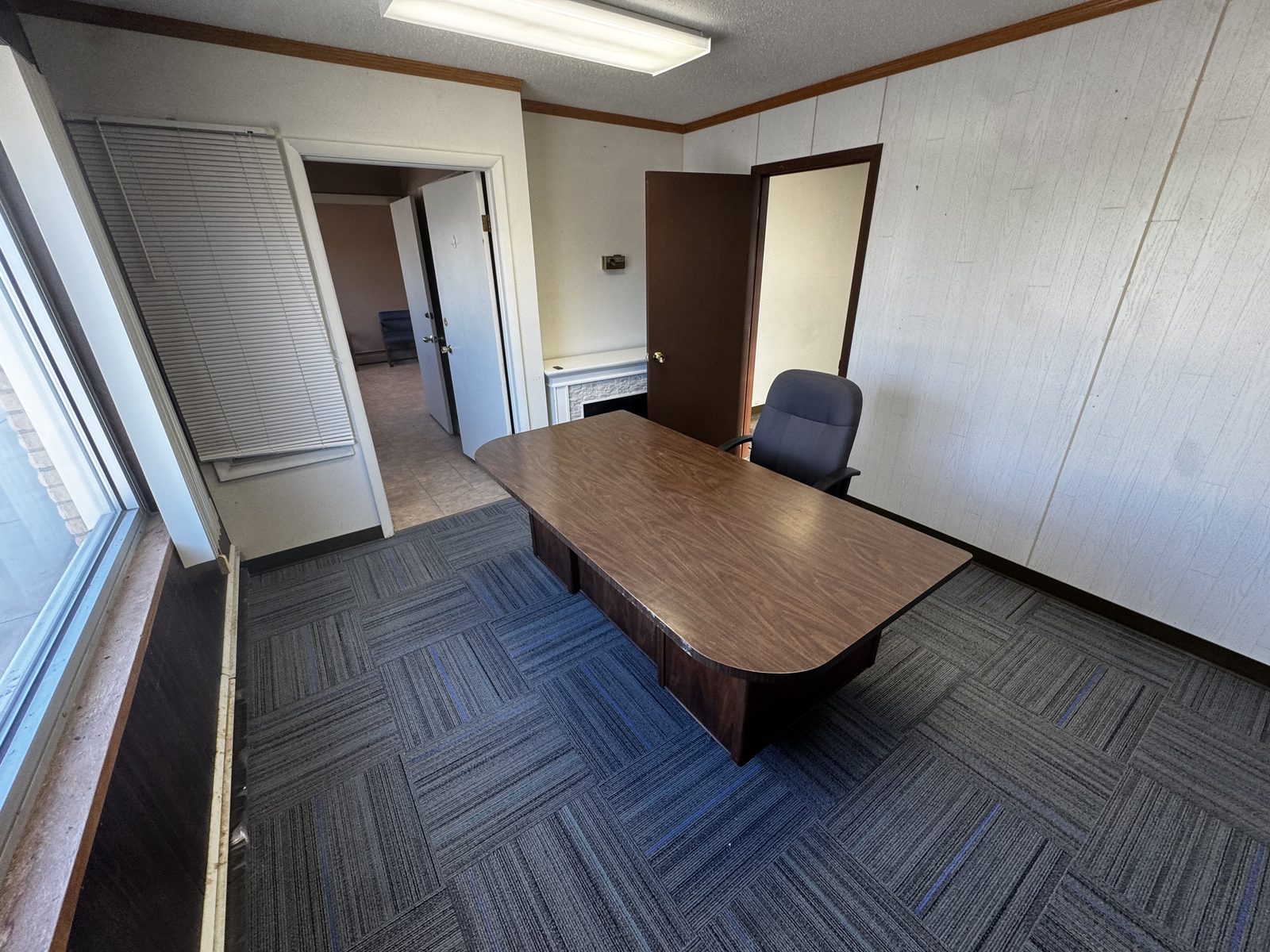 Private office in Suite A with desk, chair, and carpet-tile flooring